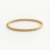 Solid Gold twist bracelet on a white background