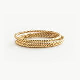 Solid Gold twist bracelet on a white background