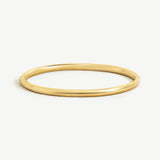 14k solid gold Namiri Bangle with polished finish, displayed on a white background.
