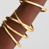 polished 14k gold bangles