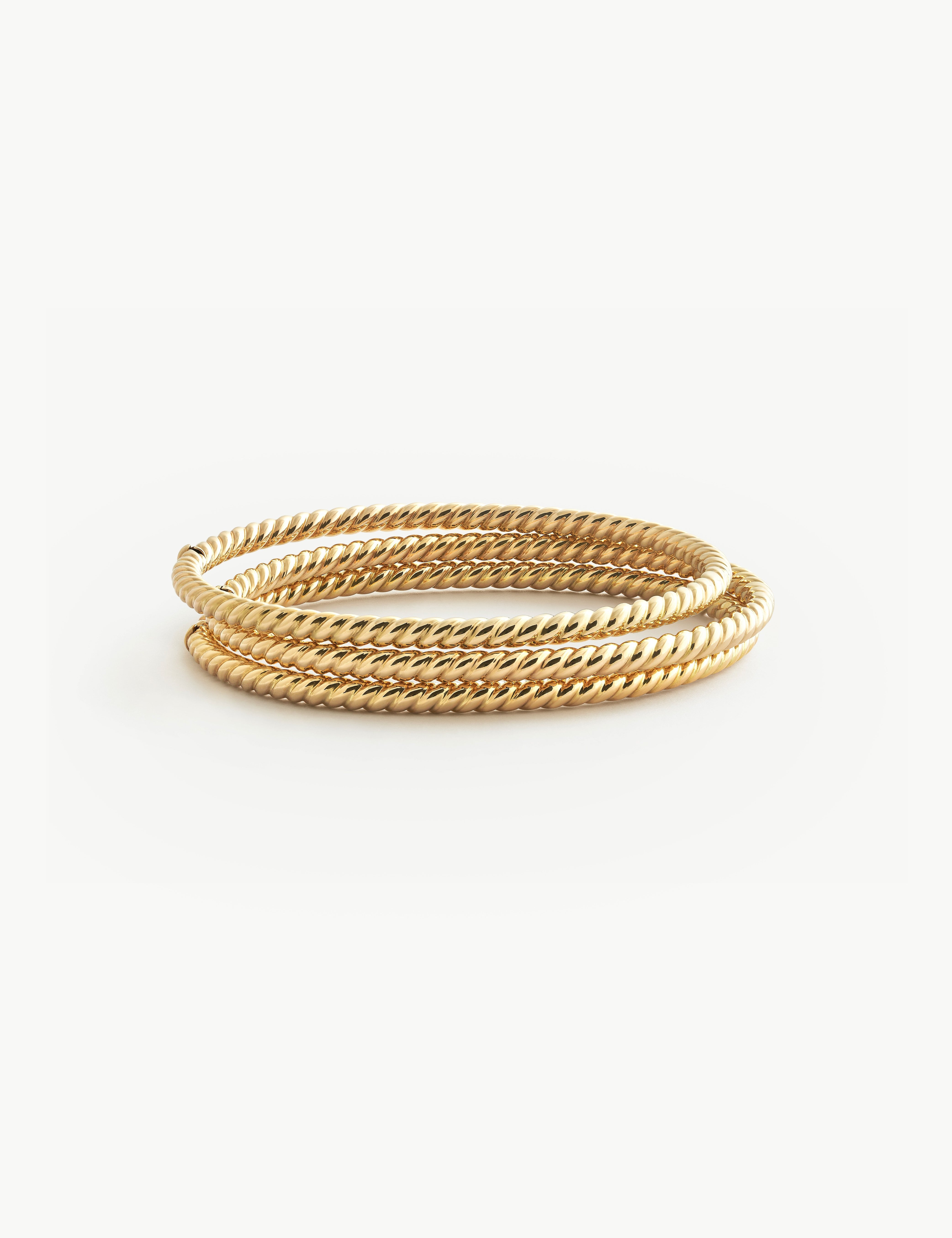 Solid Gold twist bracelet on a white background