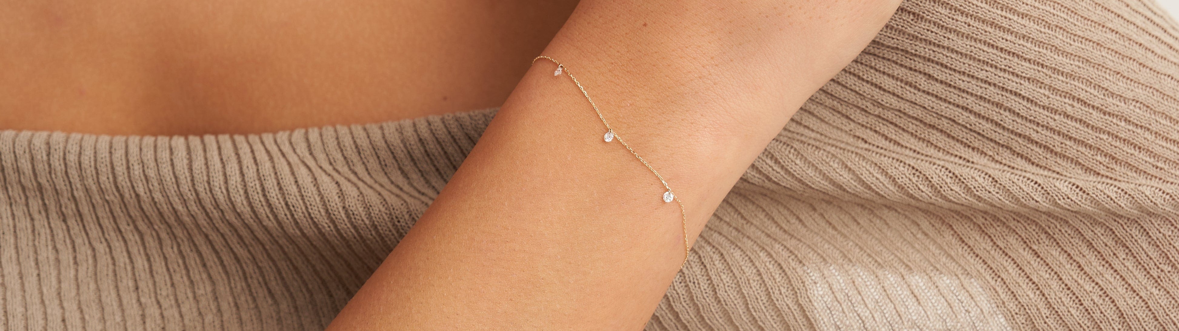 Delicate bracelet on a wrist with a neutral background